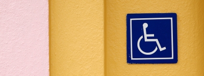 blue wheelchair sign on yellow wall