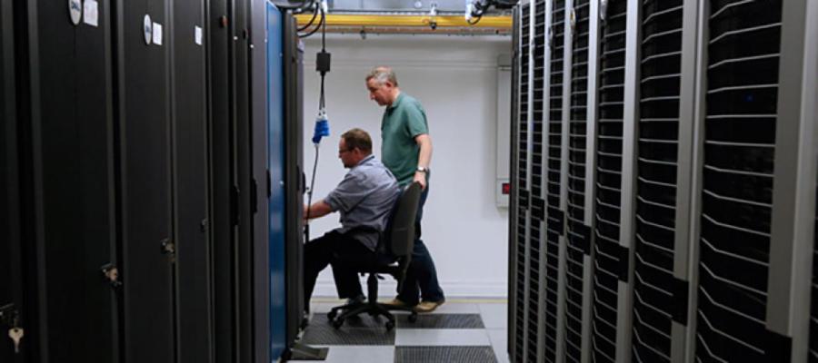 two men working in file-server room