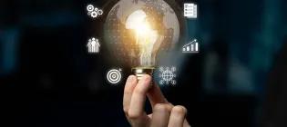 Hand hold a light bulb of research ideas