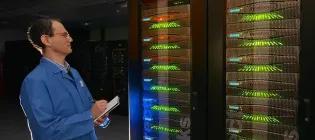 Picture of man with clipboard at super computer