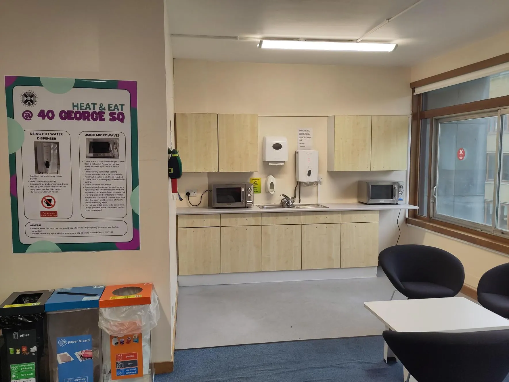 Heat and Eat at 40 George Square. The room has soft seating, a boiling water dispenser and two microwaves
