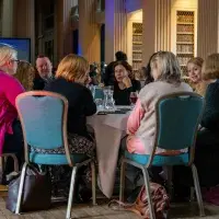 a group of people sitting at a table