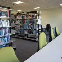 Photograph from inside the self-service study space at the western general hospital, showing a row of chairs at a desk and books behind the chairs.
