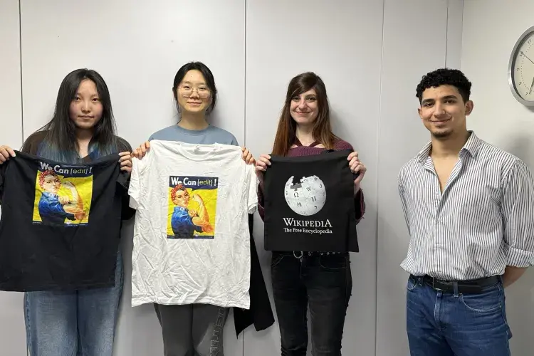 2024 achievers holding up their Wikipedia t-shirts
