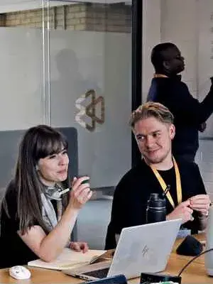 University staff in an office in discussion. 
