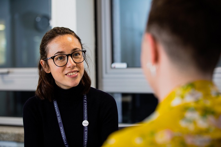 Staff member talking to a student
