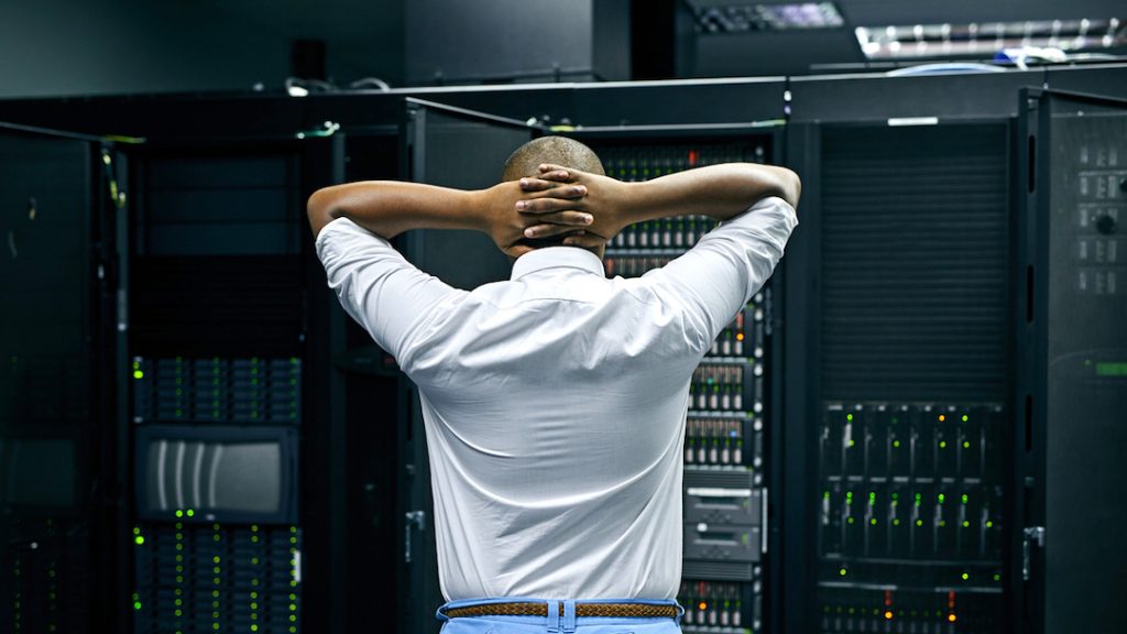 Man standing in front of a computer system