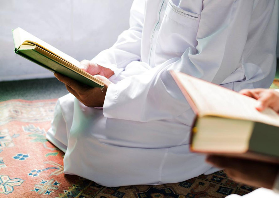 Photograph of two people holding and reading open books